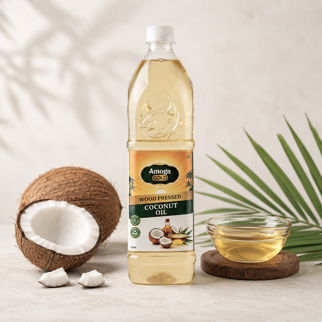 Amoga Gold coconut oil bottle with a coconut and bowl of oil on a light background